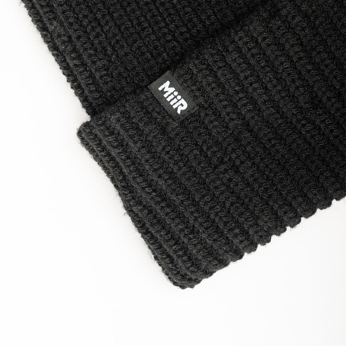 recycled-poly-rib-beanie-v9 WebPDP-RecycledPolyRibBeanie_Studio_TagDetail_Black__BNE002002OS.jpg